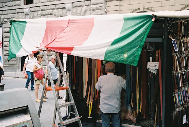 image of stall selling belts with Italian flag